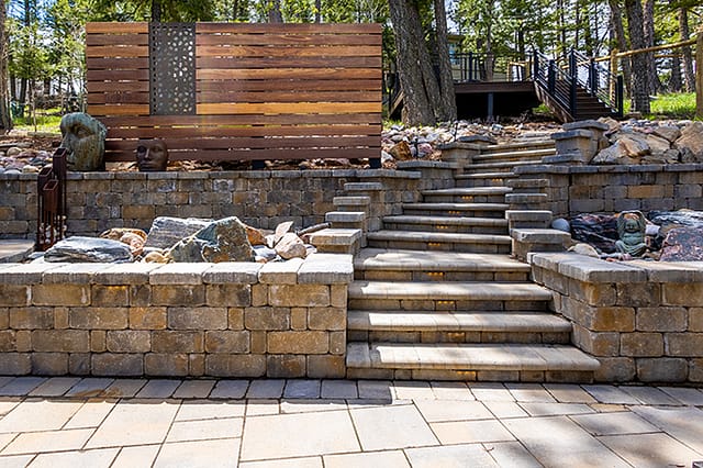 hardscape outdoor living space with retaining wall and stairs